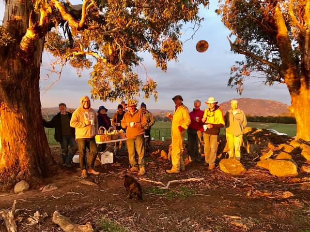 Landcare volunteers having a teabreak under the trees